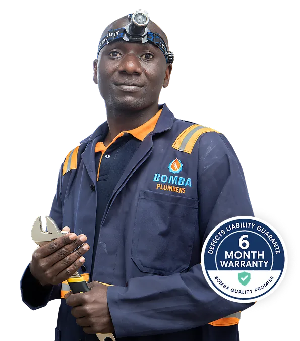 Bomba Plumbers technician wearing a headlamp and holding an adjustable wrench, with a six-month warranty badge.